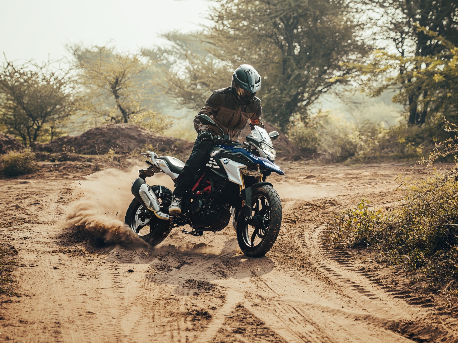 BMW G 310 GS drifting on a dusty trail