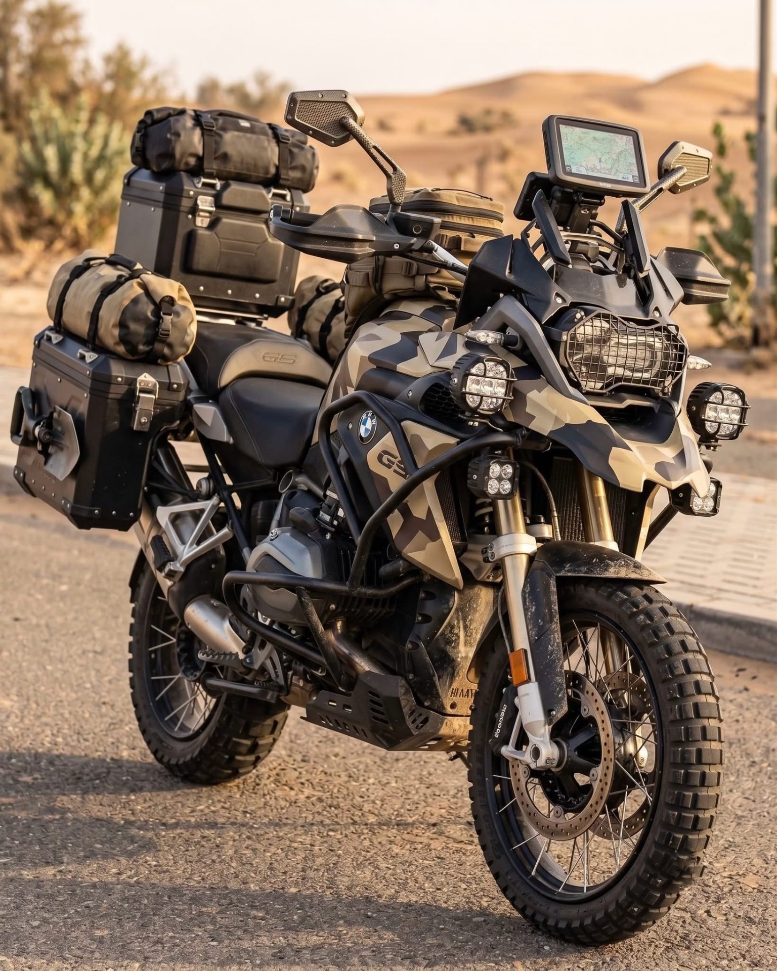 BMW R 1250 GS in desert camo parked in the Sahara