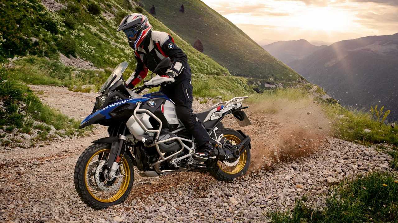 BMW R 1250 GS Adventure riding alpine mountain trail at sunset